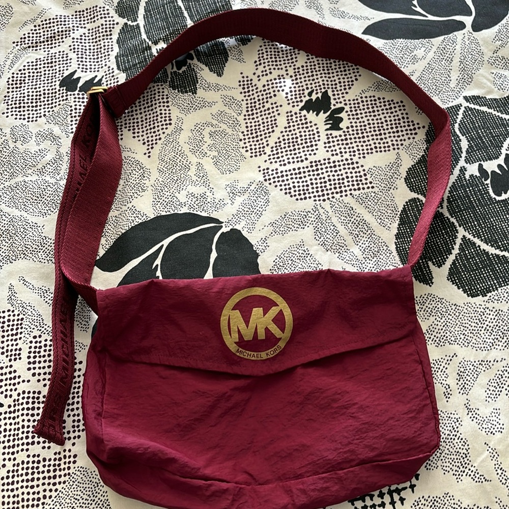 Michael Kors burgundy crossbody belt bag.